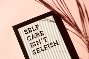 Picture of a letter board that reads "Self care isn't selfish"