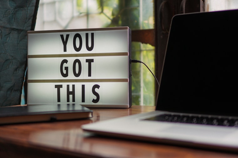 Picture of a laptop and a letter board that reads "YOU GOT THIS" on a desk