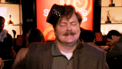 Ron dances happily with a tiny black hat attached to his head
